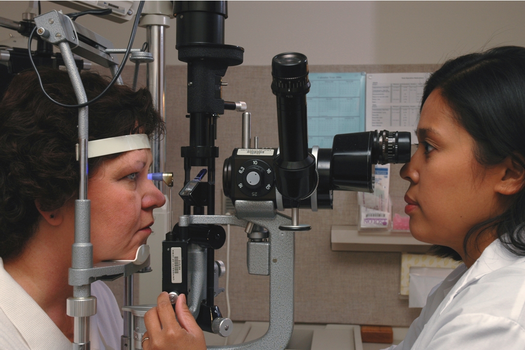 doctor performing eye examine on patient